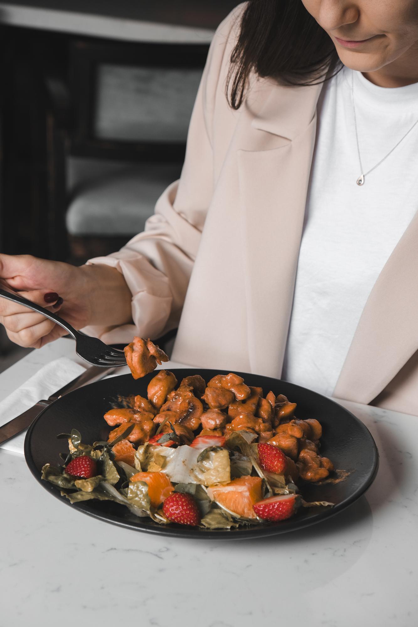 Founder plating a dish in a modern kitchen
